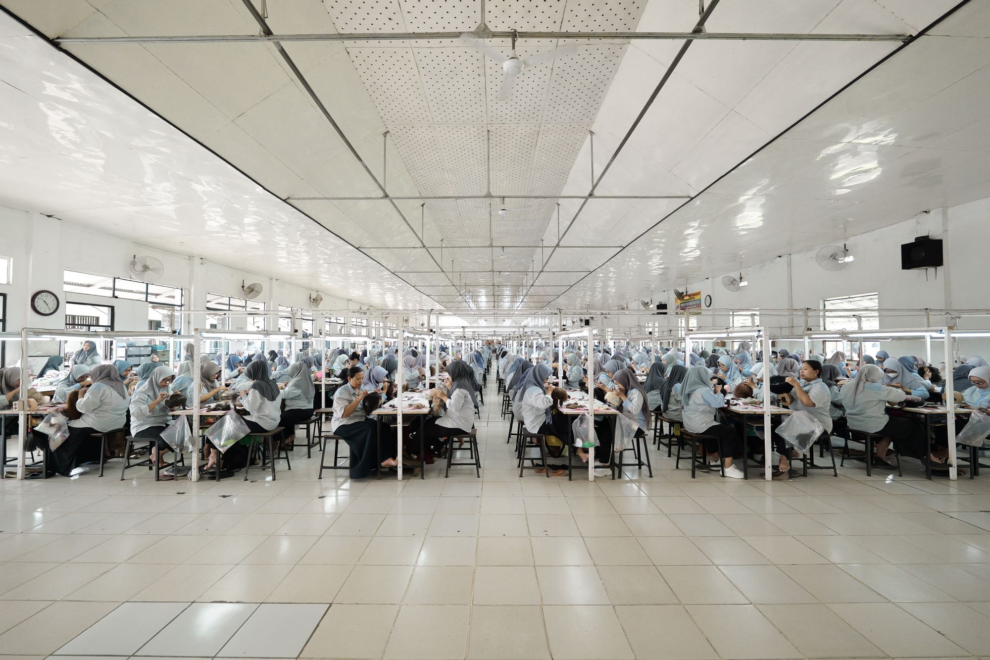 Production hall, uniformed technicians at ventilation benches